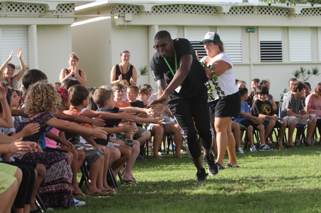 Forward Mike Thomas high-fived a row of students.