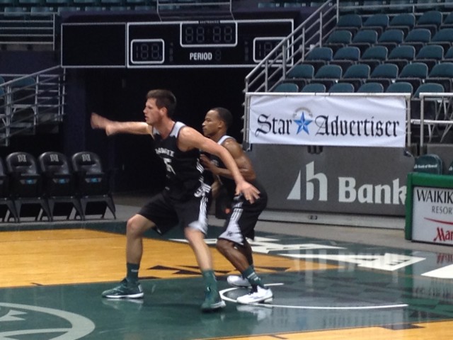 Center Stefan Jovanovic practiced posting up on guard Garrett Nevels after Monday's practice. Also, the prominent advertising in the shot is entirely coincidental.