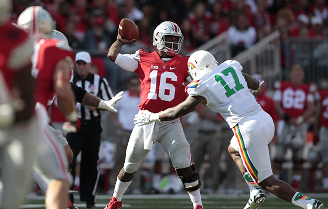 Ohio State quarterback J.T. Barrett threw under pressure from Hawaii linebacker Lance Williams in the first half Saturday.