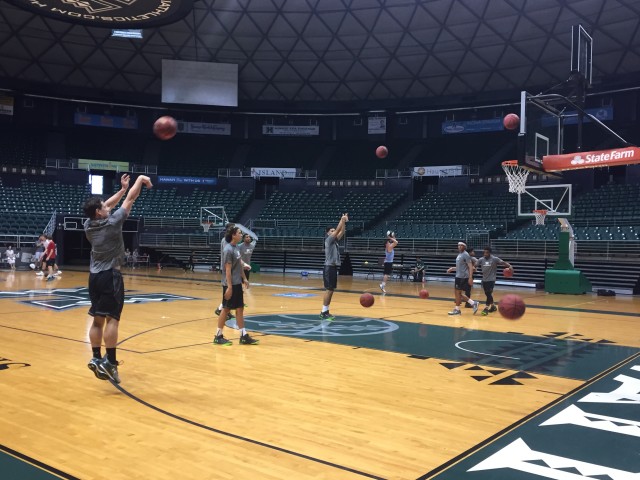 Matt Owies (left) got up a shot during a team warmup for a workout.
