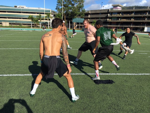 Hensley surrounded by safety Manu Hudson-Rasmussen, Roe Farris II, cornerback Cameron Hayes and running back Ryan Tuiasoa