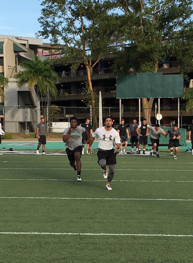 Running back Diocemy Saint Juste and slotback John Ursua